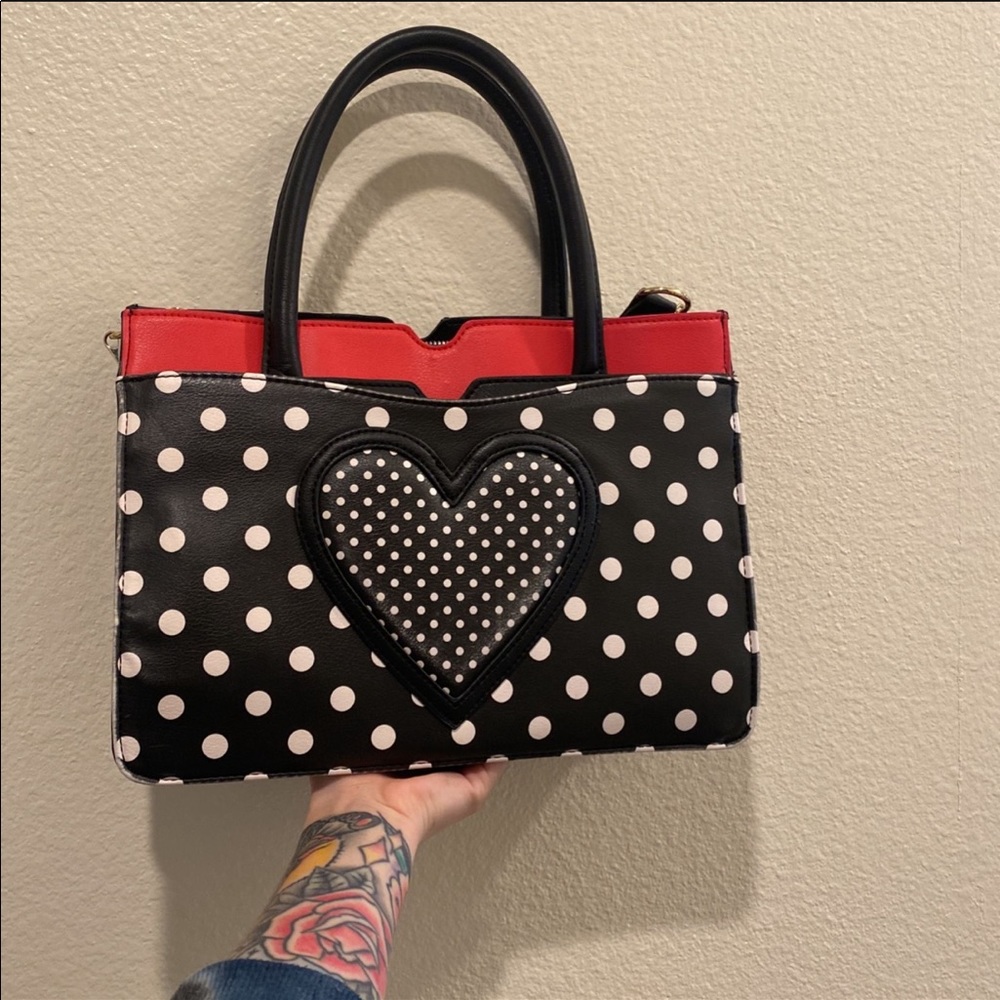 Black and white Poka dot Betsy Johnson purse with single heart on front.